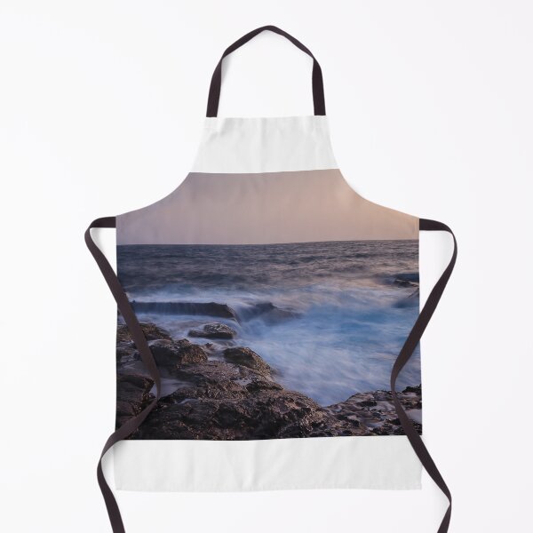 Item preview, Rocky Coastline With Waves Crashing Against Cliffs Near A Seaside Village At Dusk designed and sold by Nmallia.