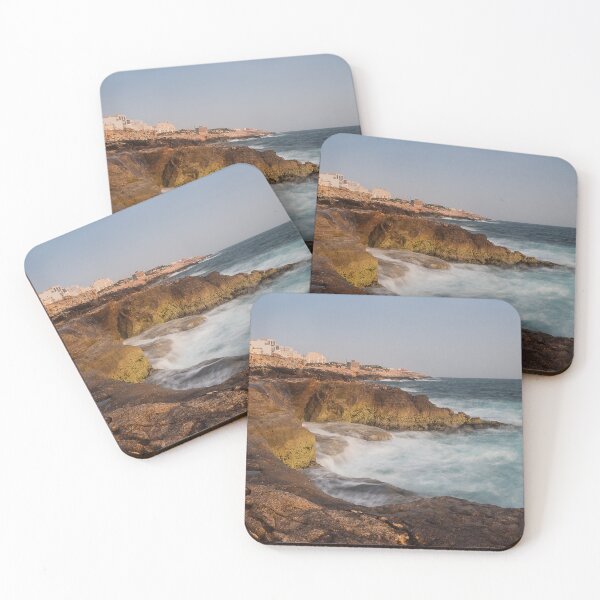 Item preview, Rocky Coastline With Waves Crashing Against Cliffs Near A Seaside Village At Dusk designed and sold by Nmallia.
