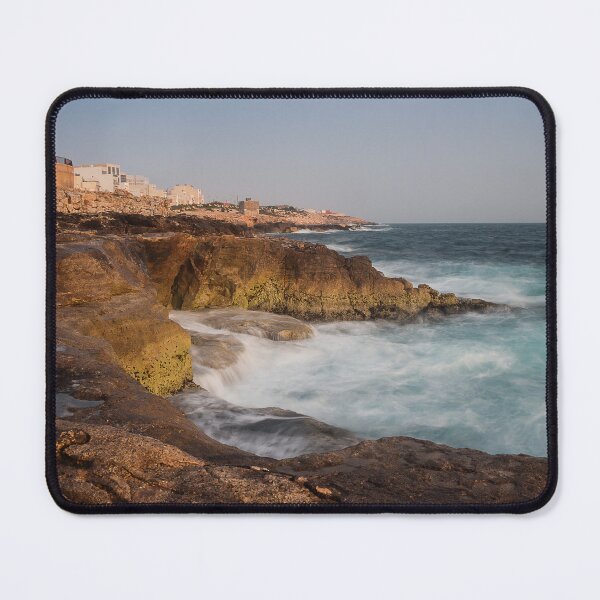 Item preview, Rocky Coastline With Waves Crashing Against Cliffs Near A Seaside Village At Dusk designed and sold by Nmallia.