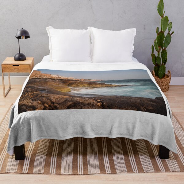 Item preview, Rocky Coastline With Waves Crashing Against Cliffs Near A Seaside Village At Dusk designed and sold by Nmallia.