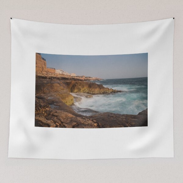 Item preview, Rocky Coastline With Waves Crashing Against Cliffs Near A Seaside Village At Dusk designed and sold by Nmallia.