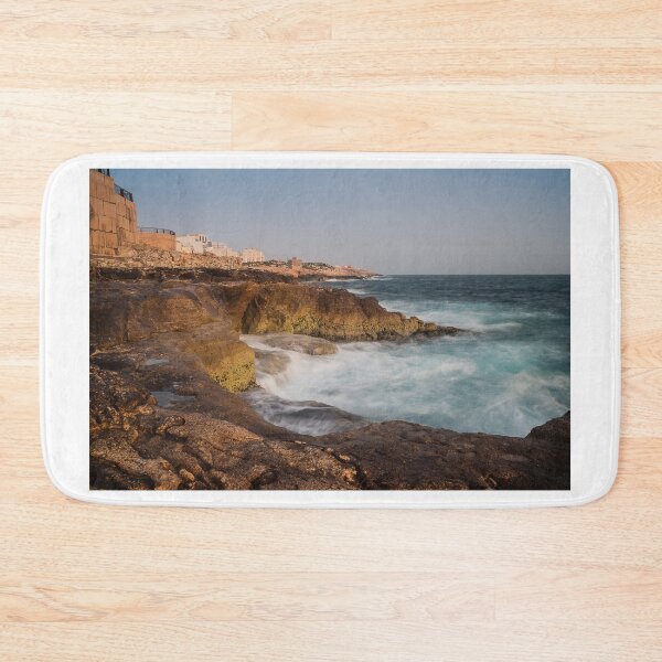 Item preview, Rocky Coastline With Waves Crashing Against Cliffs Near A Seaside Village At Dusk designed and sold by Nmallia.