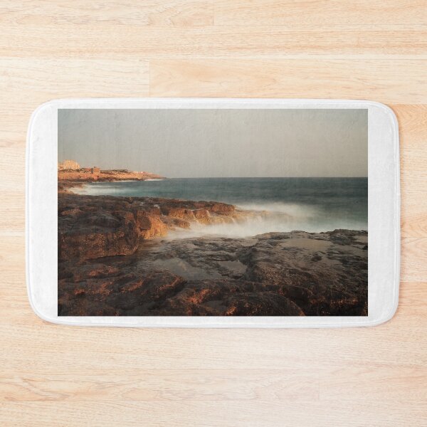 Item preview, Rocky Coastline With Waves Crashing Against Cliffs Near A Seaside Village At Dusk designed and sold by Nmallia.