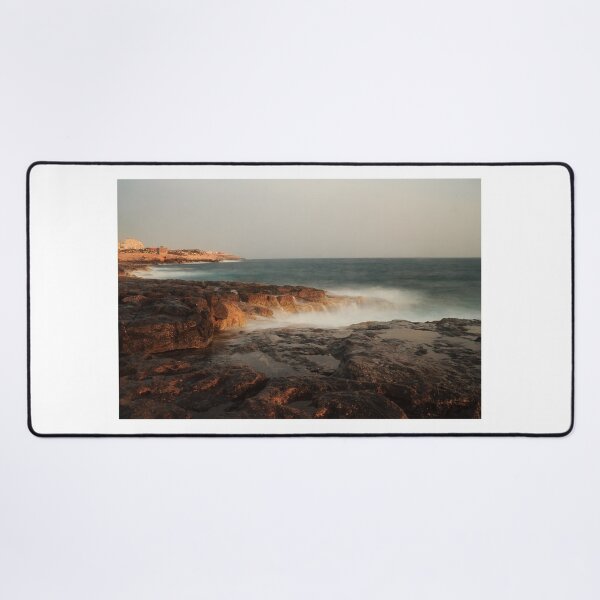 Item preview, Rocky Coastline With Waves Crashing Against Cliffs Near A Seaside Village At Dusk designed and sold by Nmallia.