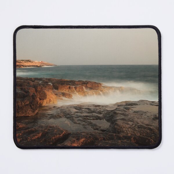 Item preview, Rocky Coastline With Waves Crashing Against Cliffs Near A Seaside Village At Dusk designed and sold by Nmallia.