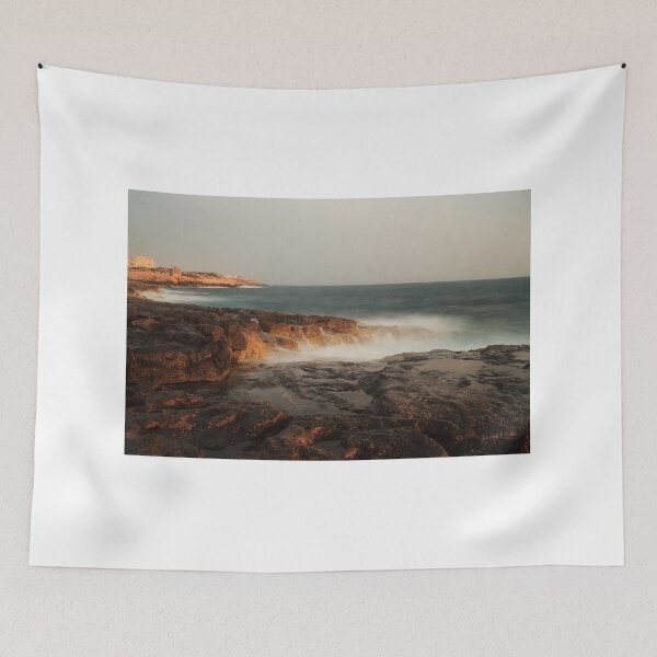 Item preview, Rocky Coastline With Waves Crashing Against Cliffs Near A Seaside Village At Dusk designed and sold by Nmallia.