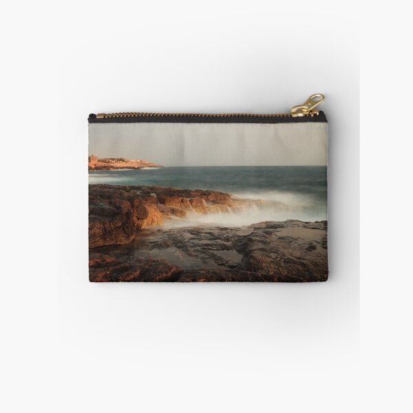 Item preview, Rocky Coastline With Waves Crashing Against Cliffs Near A Seaside Village At Dusk designed and sold by Nmallia.