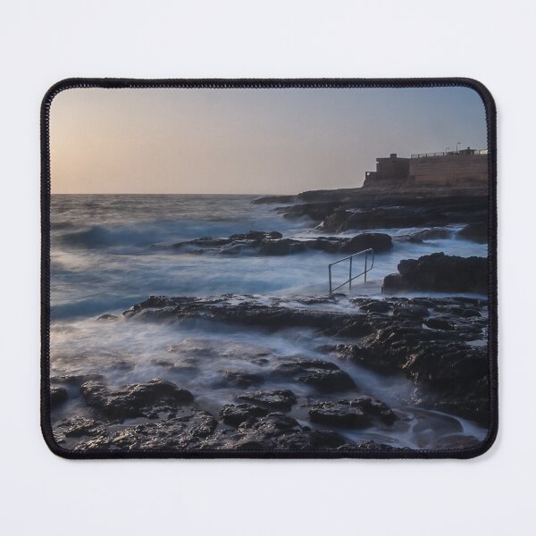 Item preview, Rocky Coastline With Waves Crashing Against Cliffs Near A Seaside Village At Dusk designed and sold by Nmallia.