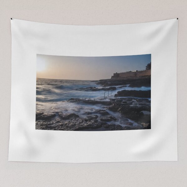 Item preview, Rocky Coastline With Waves Crashing Against Cliffs Near A Seaside Village At Dusk designed and sold by Nmallia.