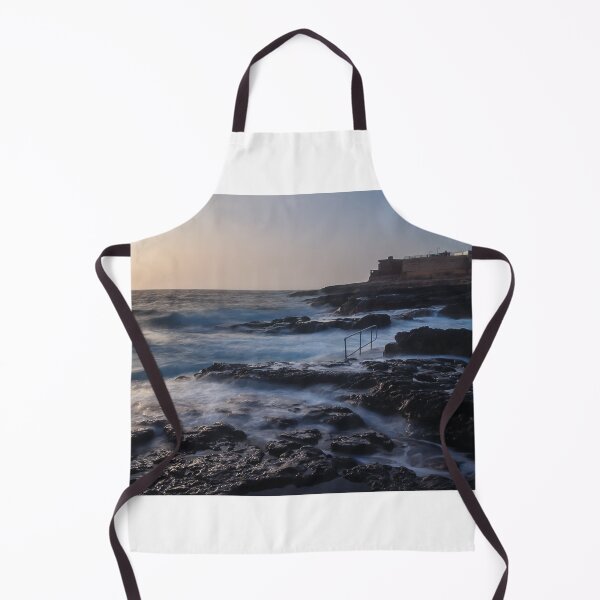 Item preview, Rocky Coastline With Waves Crashing Against Cliffs Near A Seaside Village At Dusk designed and sold by Nmallia.