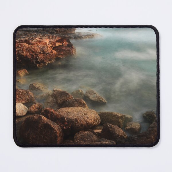 Item preview, Rocky Coastline With Waves Crashing Against Cliffs Near A Seaside Village At Dusk designed and sold by Nmallia.