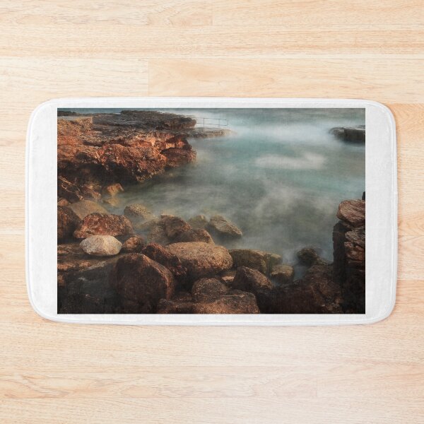 Item preview, Rocky Coastline With Waves Crashing Against Cliffs Near A Seaside Village At Dusk designed and sold by Nmallia.
