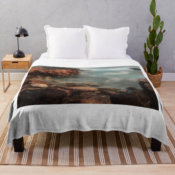 Item preview, Rocky Coastline With Waves Crashing Against Cliffs Near A Seaside Village At Dusk designed and sold by Nmallia.
