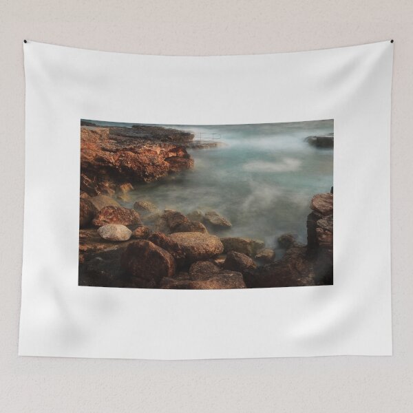 Item preview, Rocky Coastline With Waves Crashing Against Cliffs Near A Seaside Village At Dusk designed and sold by Nmallia.