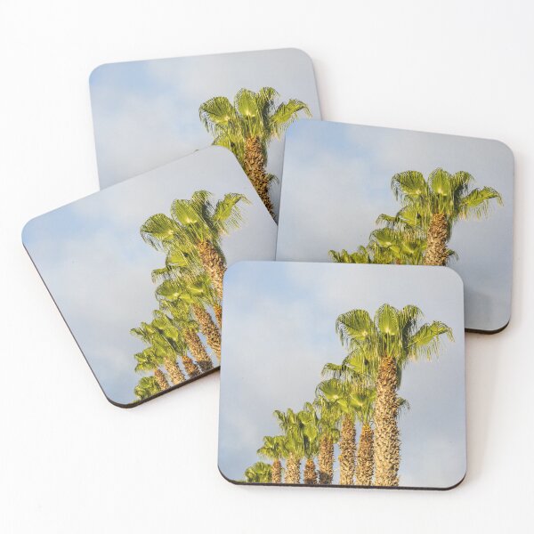 Item preview, Row of Sunlit Palm Trees Against Blue Sky With Soft Clouds in Tropical Landscape designed and sold by Nmallia.