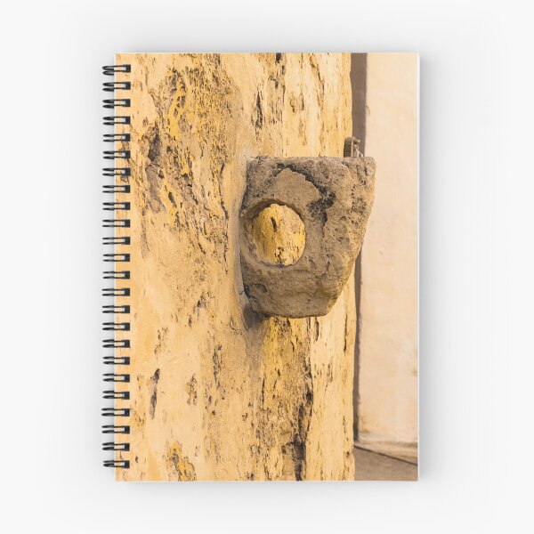 Item preview, Weathered Stone Wall With Circular Hole Detail On Ancient Yellow Plastered Architectural Facade designed and sold by Nmallia.