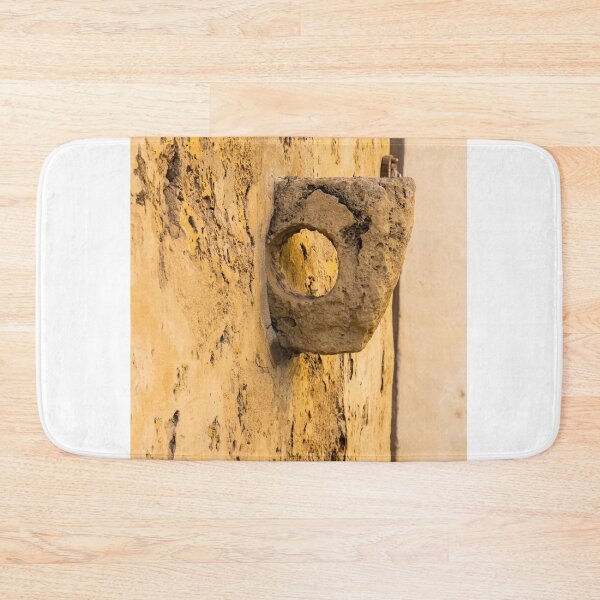 Item preview, Weathered Stone Wall With Circular Hole Detail On Ancient Yellow Plastered Architectural Facade designed and sold by Nmallia.