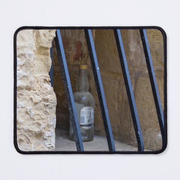 Item preview, Abandoned Glass Bottle Behind Iron Bars In Stone Window Alcove In Urban Nook designed and sold by Nmallia.