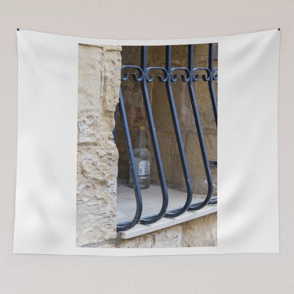Item preview, Abandoned Glass Bottle Behind Iron Bars In Stone Window Alcove In Urban Nook designed and sold by Nmallia.