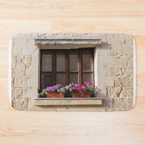 Item preview, Sunlit Stone Building Wooden Window With Colorful Flower Boxes On Mediterranean Facade designed and sold by Nmallia.