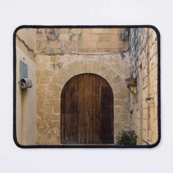 Item preview, Sunlit Stone Archway With Large Wooden Door In Narrow Mediterranean Alleyway designed and sold by Nmallia.