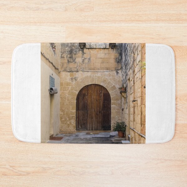 Item preview, Sunlit Stone Archway With Large Wooden Door In Narrow Mediterranean Alleyway designed and sold by Nmallia.