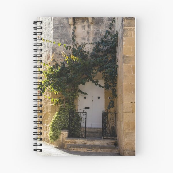 Item preview, Sunlit Ivy-Covered White Door in Warm Stone Alleyway With Wrought Iron Gate and Steps designed and sold by Nmallia.