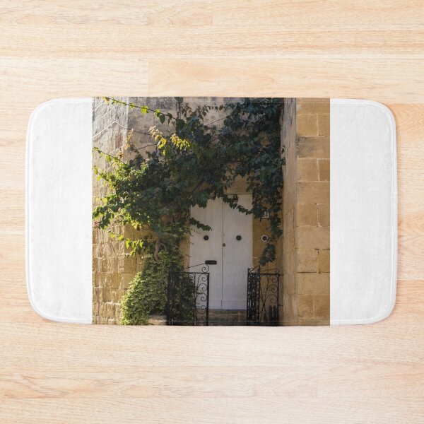 Item preview, Sunlit Ivy-Covered White Door in Warm Stone Alleyway With Wrought Iron Gate and Steps designed and sold by Nmallia.