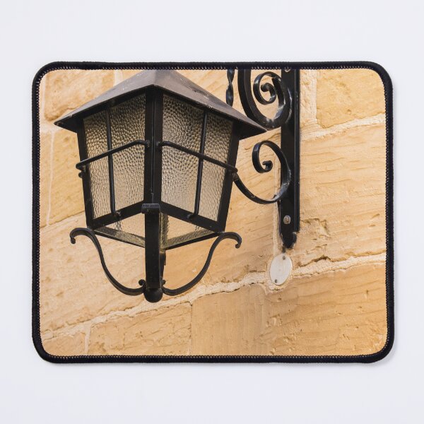 Item preview, Vintage Black Iron Lantern Wall Lamp Mounted On Sandstone Wall Outside Historic Building designed and sold by Nmallia.