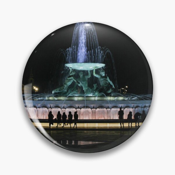 Item preview, Illuminated Night Fountain With Silhouetted People Gathered Around Water Feature in City Square designed and sold by Nmallia.