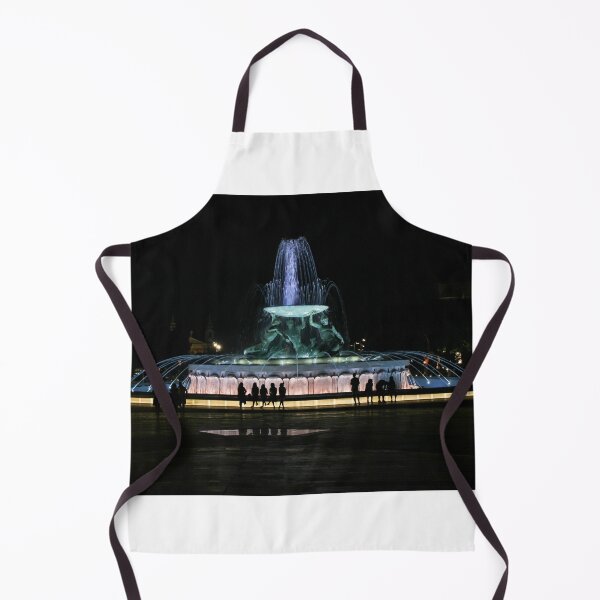 Item preview, Illuminated Night Fountain With Silhouetted People Gathered Around Water Feature in City Square designed and sold by Nmallia.