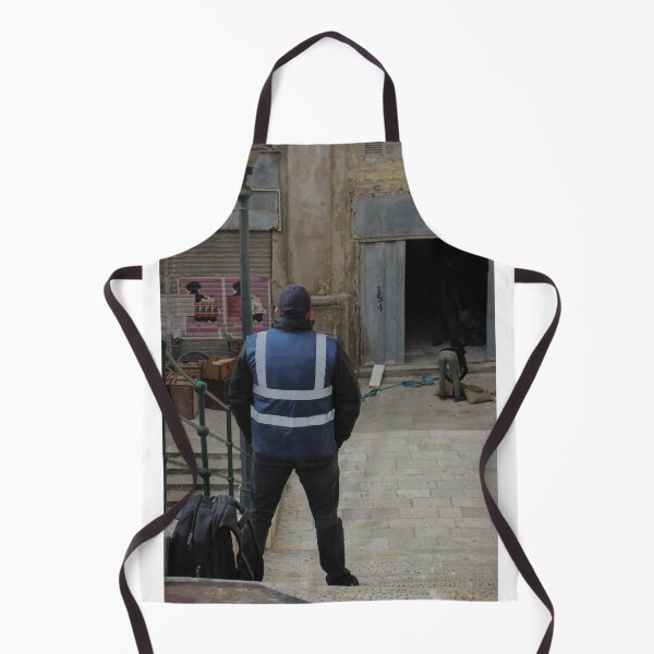 Item preview, Worker in Reflective Vest Standing on Stone Steps Outside Old Urban Building Under Renovation designed and sold by Nmallia.