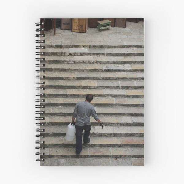 Item preview, Worker Man Carrying Plastic Jug Up Old Stone Steps Back View designed and sold by Nmallia.