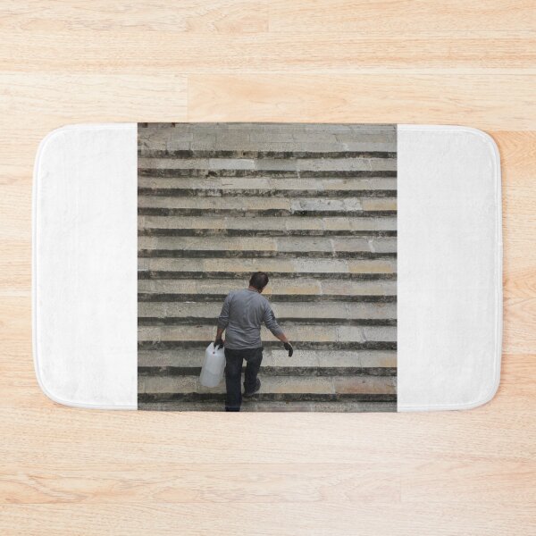 Item preview, Worker Man Carrying Plastic Jug Up Old Stone Steps Back View designed and sold by Nmallia.