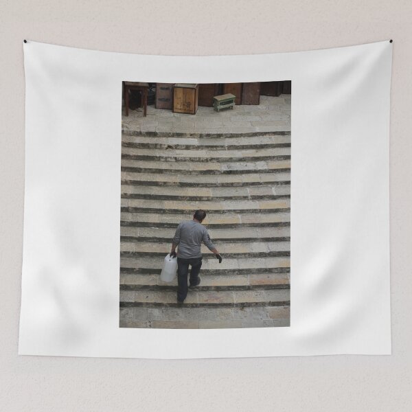 Item preview, Worker Man Carrying Plastic Jug Up Old Stone Steps Back View designed and sold by Nmallia.