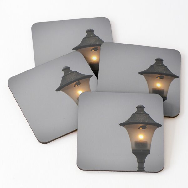 Item preview, Glowing Vintage Street Lamp at Dusk Casting Warm Light Against Overcast Sky designed and sold by Nmallia.