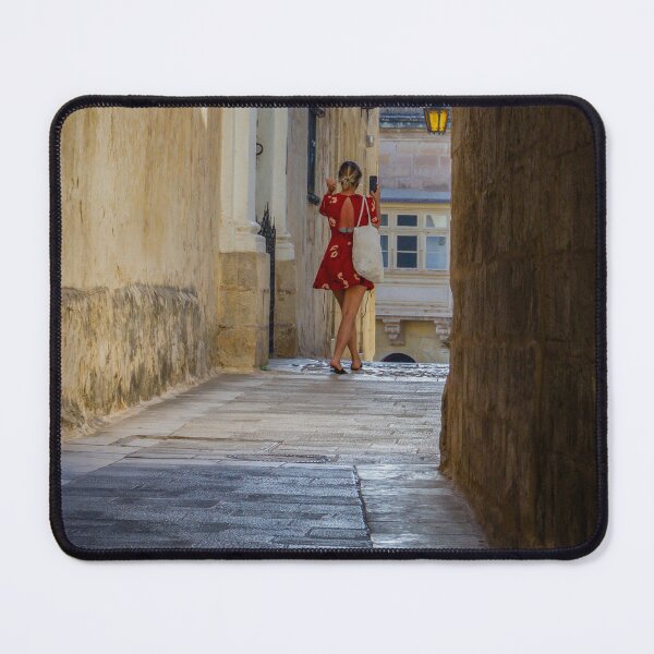 Item preview, Woman in Red Dress Walking Through Narrow Historic Alley Taking Photo of Old Town Architecture designed and sold by Nmallia.
