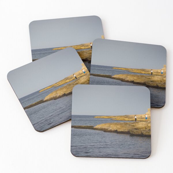 Item preview, Couple Standing On Rocky Coastline Near Calm Sea With Old Stone Lookout At Sunset designed and sold by Nmallia.