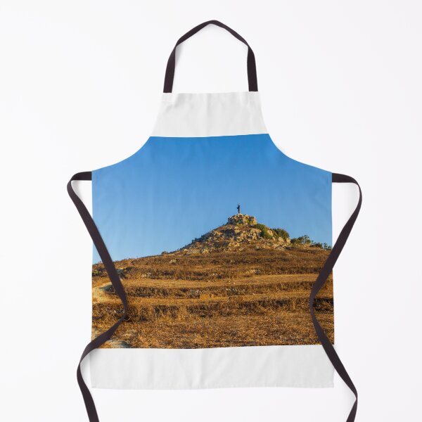Item preview, Solitary Statue on Rocky Hill Overlooking Winding Trail Through Golden Dry Grass Under Blue Sky designed and sold by Nmallia.