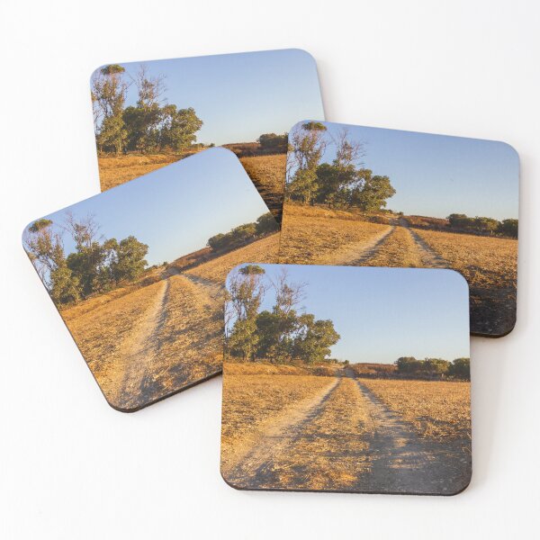 Item preview, Dirt Road Through Dry Field at Golden Hour With Trees in Rural Countryside Landscape designed and sold by Nmallia.