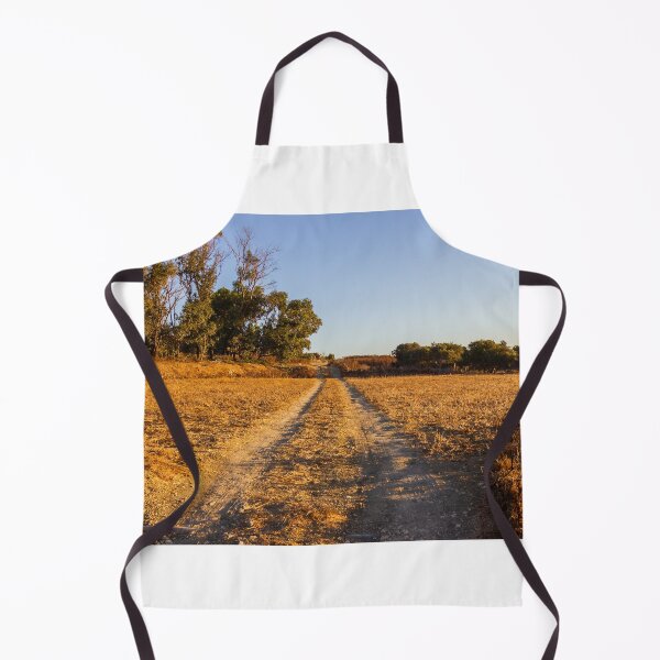 Item preview, Dirt Road Through Dry Field at Golden Hour With Trees in Rural Countryside Landscape designed and sold by Nmallia.