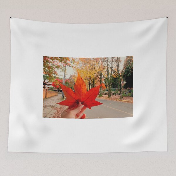 Item preview, Autumn Magic: Holding a Red Maple Leaf. Vibrant Red Autumn Maple Leaf in Hand designed and sold by TaynaraVieira.