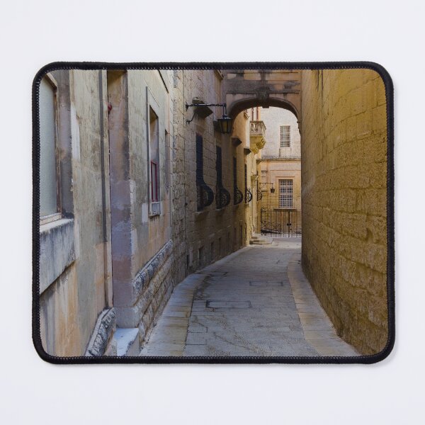 Item preview, Narrow Stone Alleyway Through Historic Mediterranean Town With Arch, Windows and Soft Light designed and sold by Nmallia.