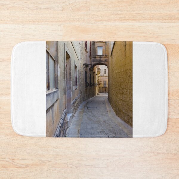 Item preview, Narrow Stone Alleyway Through Historic Mediterranean Town With Arch, Windows and Soft Light designed and sold by Nmallia.