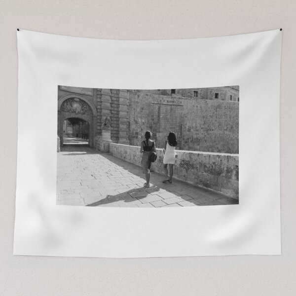 Item preview, Two Women Walking Along Historic Stone Ramparts by Ancient Arch in Mediterranean Old Town designed and sold by Nmallia.