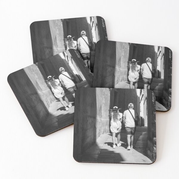 Item preview, Couple Walking Down Narrow Sunlit European Alleyway in Black and White Street Photography designed and sold by Nmallia.