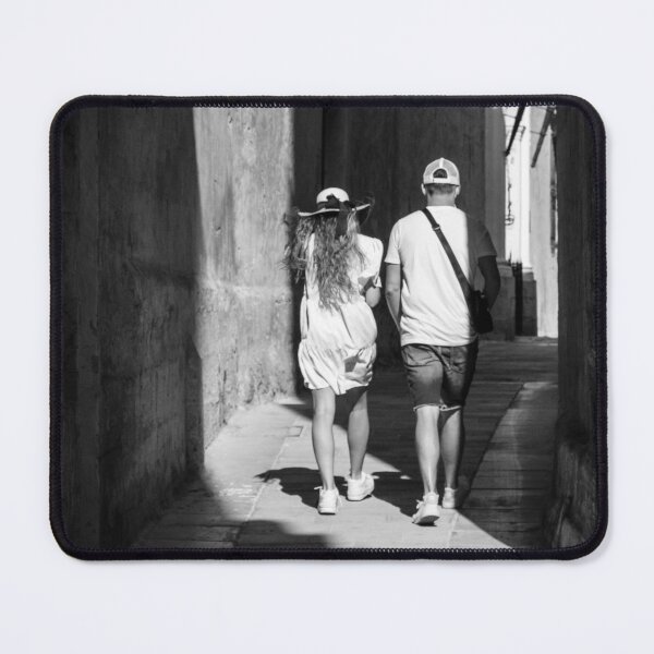 Item preview, Couple Walking Down Narrow Sunlit European Alleyway in Black and White Street Photography designed and sold by Nmallia.