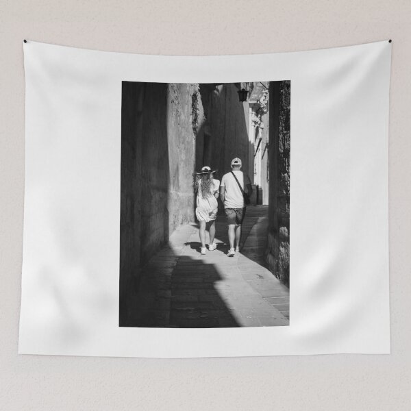 Item preview, Couple Walking Down Narrow Sunlit European Alleyway in Black and White Street Photography designed and sold by Nmallia.