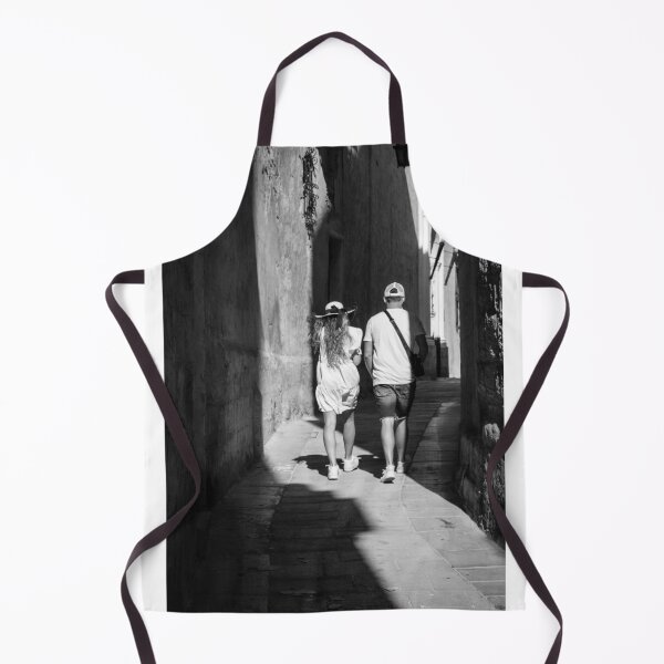Item preview, Couple Walking Down Narrow Sunlit European Alleyway in Black and White Street Photography designed and sold by Nmallia.