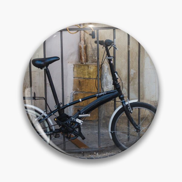 Item preview, Black Folding Bicycle Locked to Iron Rail on Cobblestone Street Beside Old Stone Wall designed and sold by Nmallia.